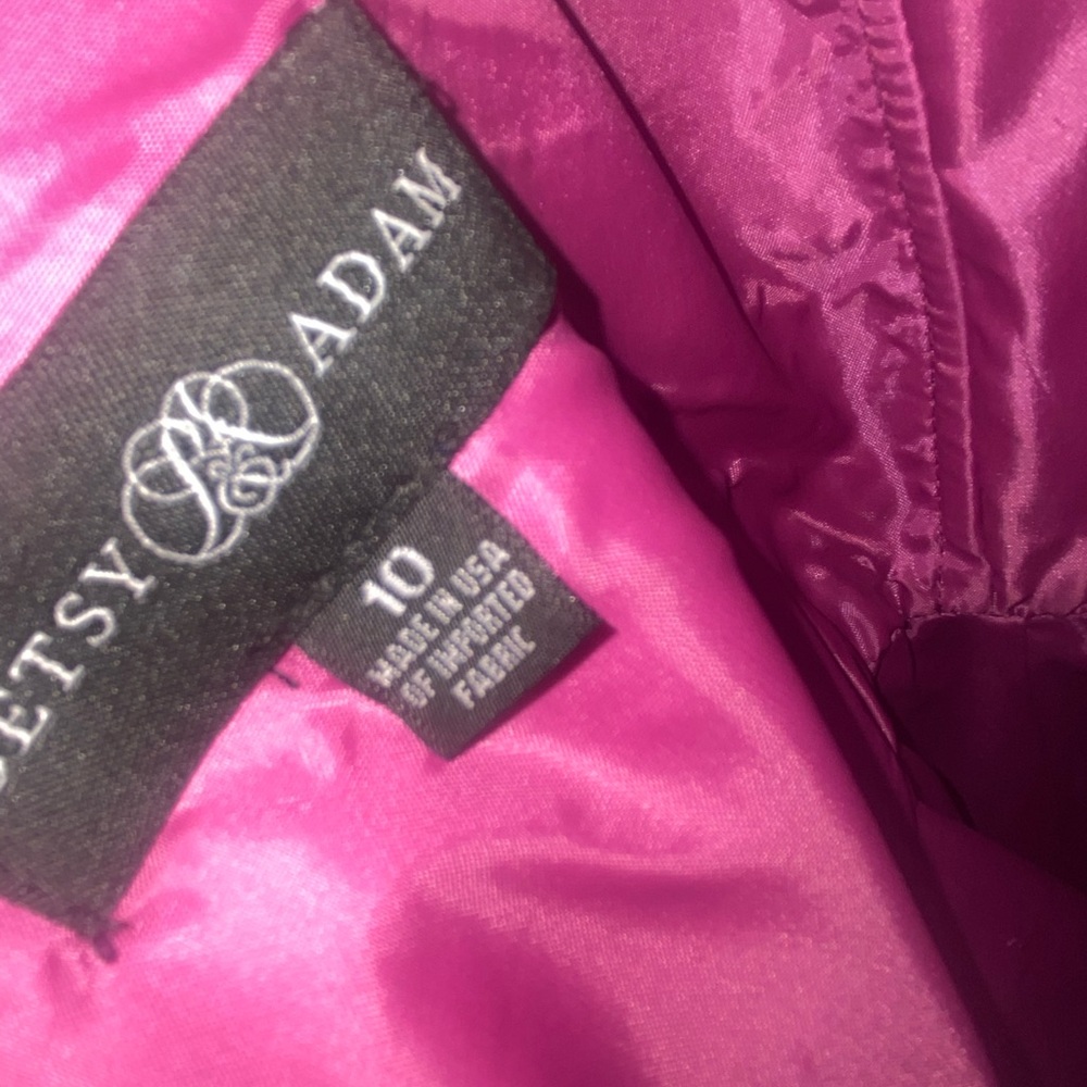 Fuchsia ballgown style dress by Betsy and Adam with pockets.